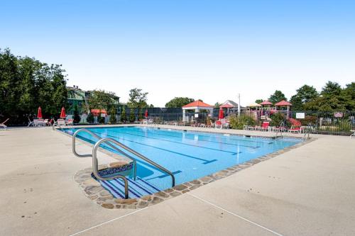 a large swimming pool with a bench next to it at Bayside Bethany Lakes N Mill #114 in Ocean View