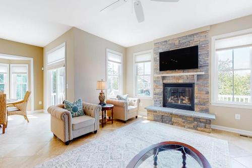 a living room with a fireplace and a tv at Bayside Resort --- 38958 Aster Way in Selbyville