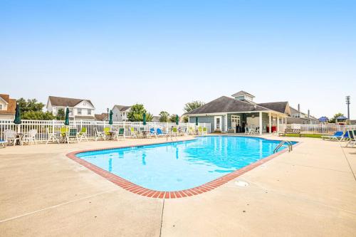a swimming pool at a resort with blue water at Swann Cove - 36858 Herring in Selbyville