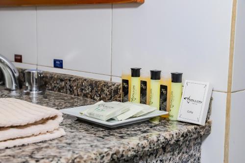 a kitchen counter with a counter top with a sink and towels at Nobile Hotel Papillon in Bella Vista