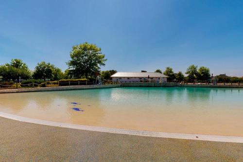 a large pool of water with a building in the background at The Peninsula --- 22308 Dune Cir 74 in Millsboro