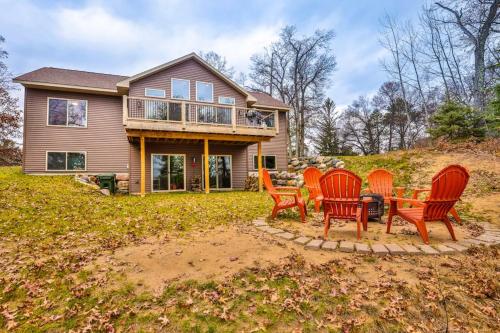 a group of chairs sitting around a table in front of a house at A Place To Gather in Tomahawk