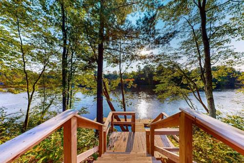 a wooden bridge over a body of water at Black Bear Cabin in Tomahawk