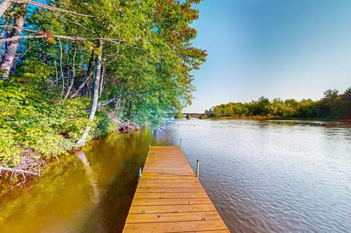 a wooden dock in the middle of a lake at Black Bear Cabin in Tomahawk