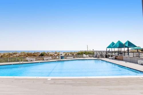 a swimming pool with a view of the ocean at Sea Colony - 2D Brandywine Garden House Rd in Bethany Beach