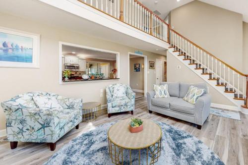 a living room with two chairs and a table at 112 Loganberry Lane in Rehoboth Beach