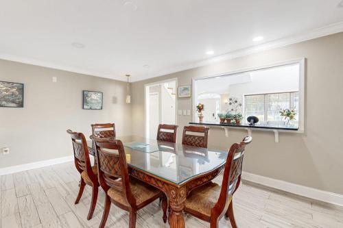 a dining room with a glass table and chairs at 112 Loganberry Lane in Rehoboth Beach