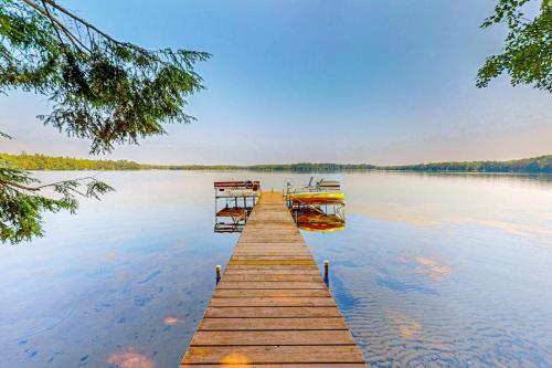 a dock on a lake with boats in the water at Two Sisters Lakeside in Rhinelander