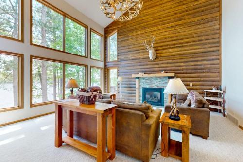 a living room with a couch and a fireplace at Pickerel Point Home in Saint Germain