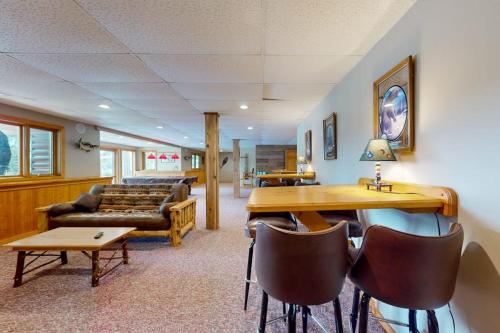 a living room with a couch and a table and chairs at Pickerel Point Home in Saint Germain