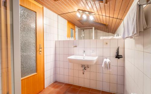 a bathroom with a sink and a mirror at Gästehaus Kaindl in Reit im Winkl