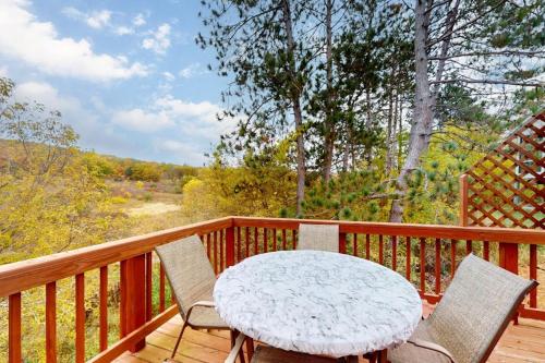 a white table and chairs on a wooden deck at Running Fox Farm in Baraboo