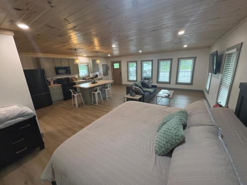 a bedroom with a large bed and a kitchen at The Hideaway at Wolf Creek in Nancy