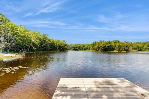 a view of a river with a wooden dock at Blue Jay Cabin in Rhinelander