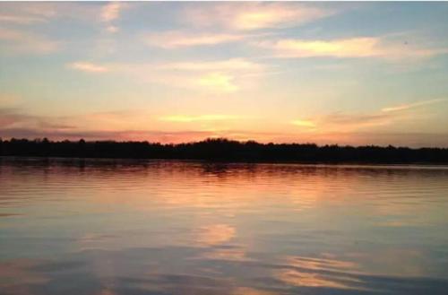 a sunset over a large body of water at Timber Lodge Retreat in Rhinelander