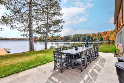 a table and chairs with a view of a lake at Timber Lodge Retreat in Rhinelander
