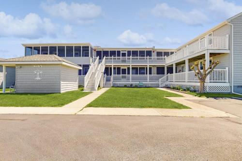 a large building with a lawn in front of it at 37534 Lighthouse Rd #202 in Fenwick Island