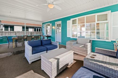 a porch with wicker furniture and a table at Rehoboth Beach Anna B St in Rehoboth Beach