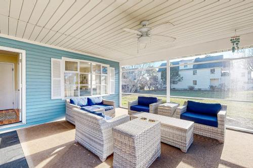a porch with wicker furniture and a ceiling fan at Rehoboth Beach Anna B St in Rehoboth Beach