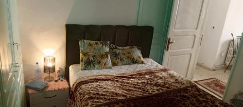 a bedroom with a bed with a large headboard at Dar Cherif in Kasbah