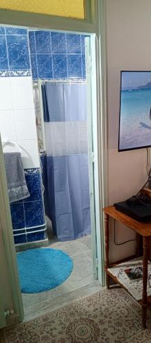 a bathroom with a shower with a glass door at Dar Cherif in Kasbah