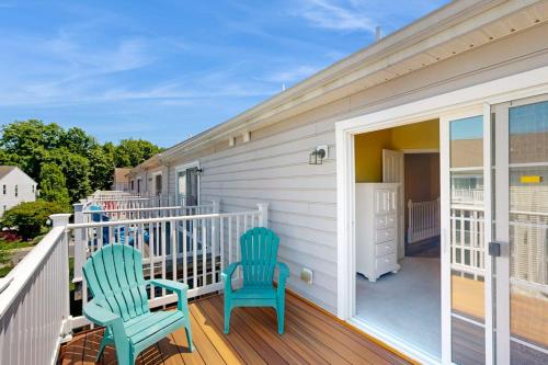 two blue chairs sitting on the porch of a house at Rehoboth Crossing 19915 Ames Dr in Rehoboth Beach