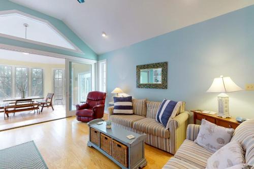 a living room with a couch and a table at Salt Pond -- 273 Oyster Shell Cove in Bethany Beach