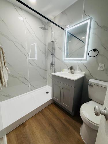 a bathroom with a sink and a shower and a toilet at AC Suites in Atlantic City