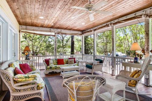 a screened in porch with chairs and a ceiling fan at Rehoboth Beach --- 6 Holly Road in Rehoboth Beach