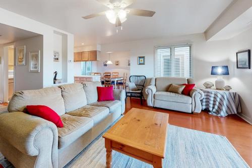 a living room with two couches and a table at Stewards Watch -- 539C Hudson in Bethany Beach