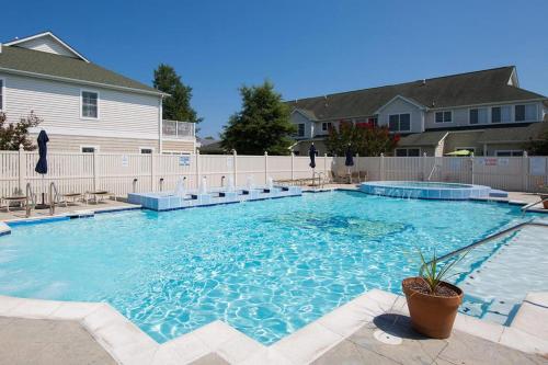 a large swimming pool in front of a house at The Tides --- 19979 Sandy Bottom Circle, Unit #504 in Rehoboth Beach
