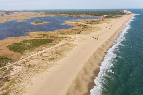 an aerial view of a beach next to the ocean at The Tides --- 19979 Sandy Bottom Circle, Unit #504 in Rehoboth Beach