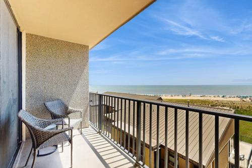a balcony with two chairs and a view of the beach at Sea Colony --- 508 Brandywine house in Bethany Beach