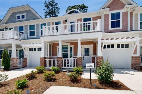a large house with a balcony on the front at The Peninsula --- 22198 Dune Cir in Millsboro