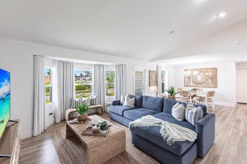 a living room with a blue couch and a table at Vanessas Villa in Marco Island
