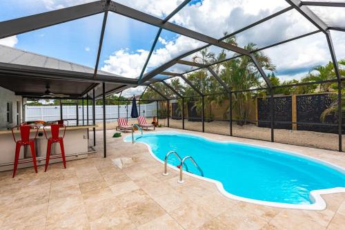 a swimming pool with a glass canopy over it at Vanessas Villa in Marco Island