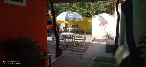 a patio with an umbrella and a table and chairs at 7 duendes in Salta
