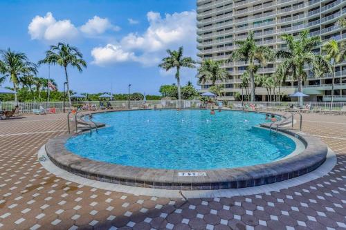 a large swimming pool in front of a large building at Seaview Sunsets in Marco Island