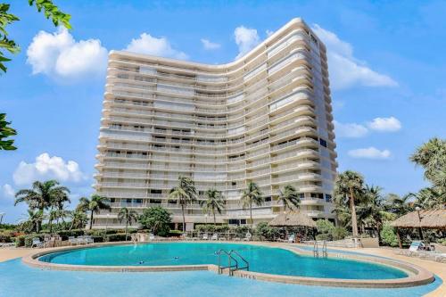 a large hotel with a pool and a resort at The Breezy Perch in Marco Island
