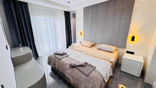 a small bedroom with a bed and a window at Villa Maris Belek Villa in Belek