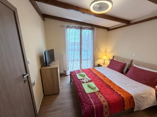 a bedroom with a large bed and a television at Villa Elena ΝΕΑΠΟΛΗ ΒΟΙΩΝ in Áyioi Apóstoloi