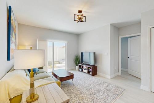a living room with a couch and a tv at Sunny Shores- Sunrise in Englewood