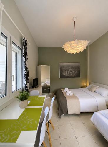 a bedroom with a bed and a dining room with a table at Venice Studios & Apartments in Stavros