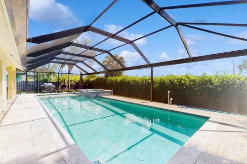 an indoor swimming pool with a glass roof at The Sunshine Social in Naples