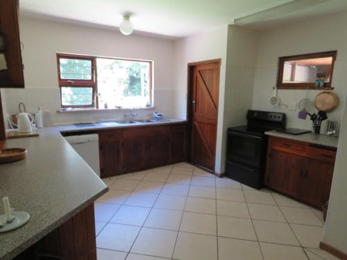 a kitchen with a sink and a stove at Natures Way Farmhouse in The Crags