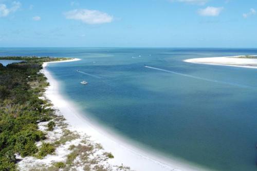 a view of a beach with a boat in the water at Lovers Key Resort 1107 in Fort Myers Beach