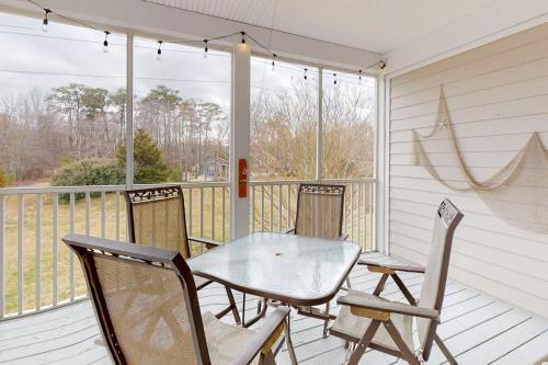 a porch with a glass table and chairs at Bear Trap Dunes 132H October Glory Ave in Ocean View