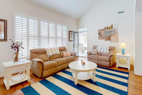 a living room with a couch and a table at Bear Trap Dunes 132H October Glory Ave in Ocean View