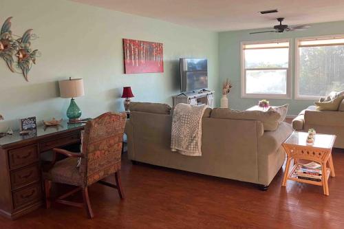 a living room with a couch and a table at Franzone Fun in Saint James City