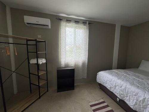 a bedroom with a bed and a book shelf at Vacation Guesthouse in Paix Bouche